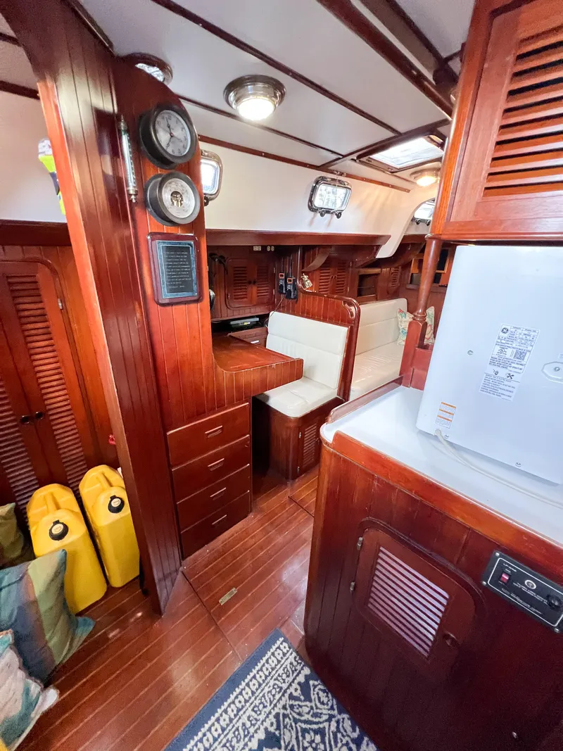 Slide: The Image of Interior of 1986 Tayana Vancouver 42 sailboat with wooden furnishings and nautical decor. - 33