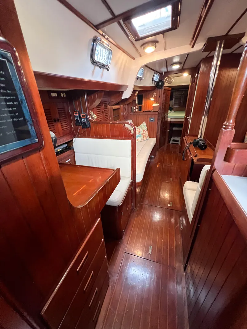 Slide: The Image of Interior of 1986 Tayana Vancouver 42 yacht with polished wood and cozy seating. - 34