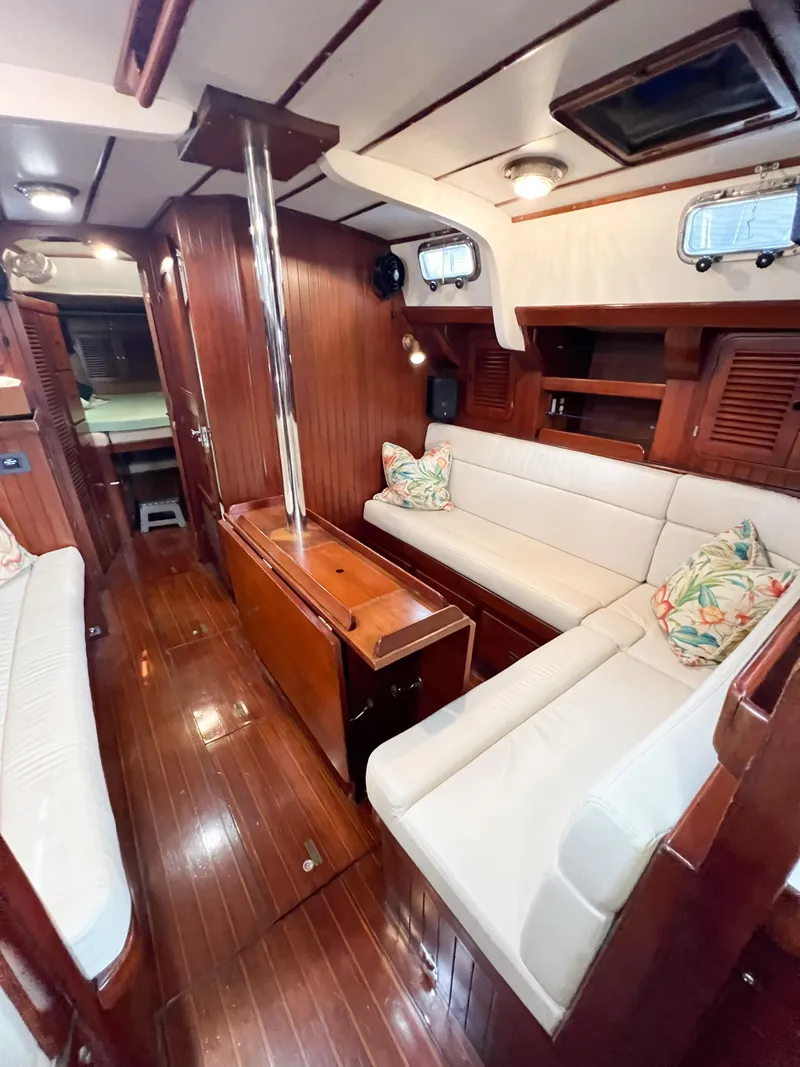 Slide: The Image of Interior of 1986 Tayana Vancouver 42 yacht with wooden finish and white seating. - 36