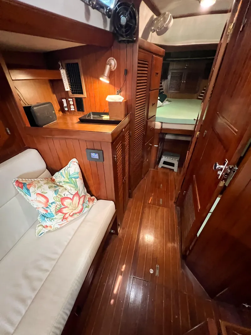 Slide: The Image of Interior of 1986 Tayana Vancouver 42 yacht with wooden finish and cozy seating area. - 37