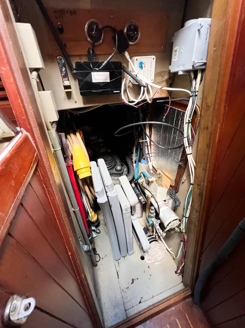 Slide: The Image of Electrical compartment of a 1986 Tayana Vancouver 42 sailboat, showing wiring and equipment. - 38