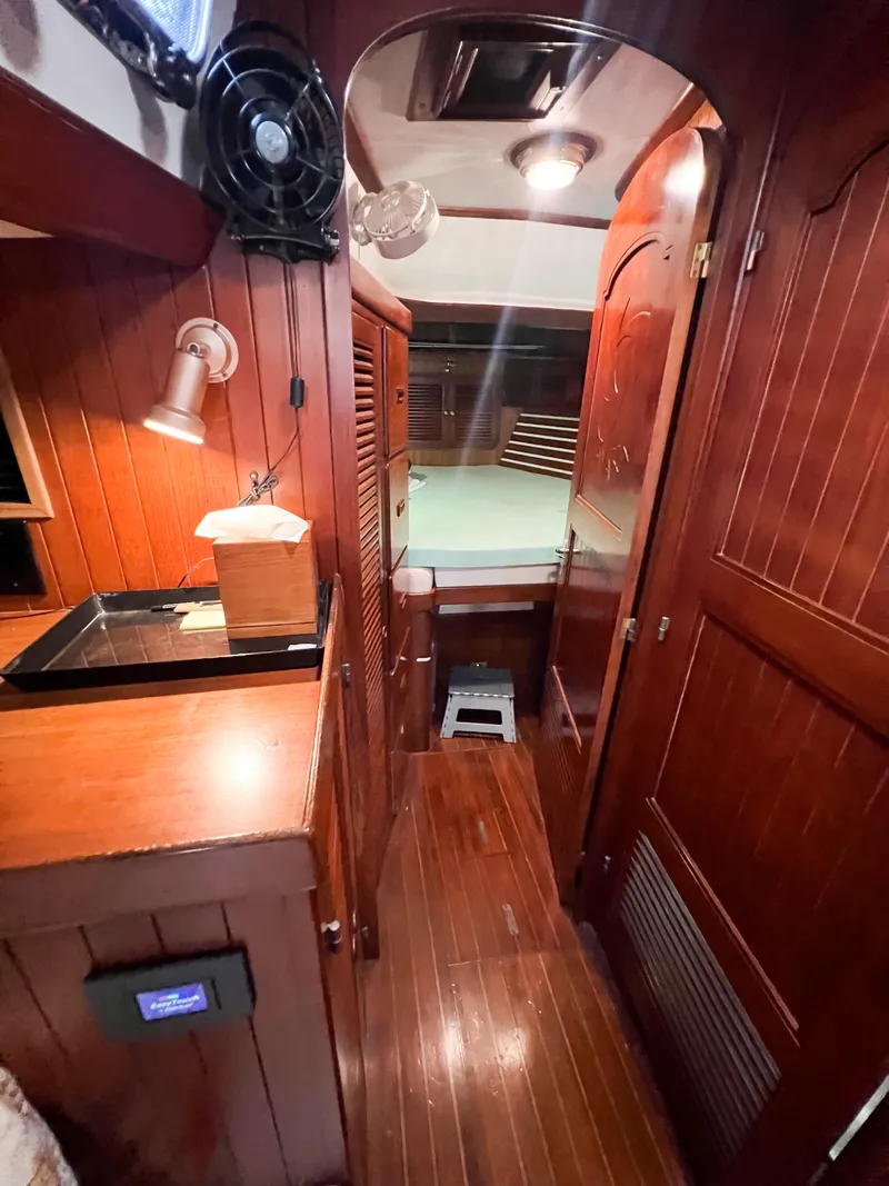 Slide: The Image of Interior of 1986 Tayana Vancouver 42 sailboat with wooden paneling and cozy cabin space. - 40