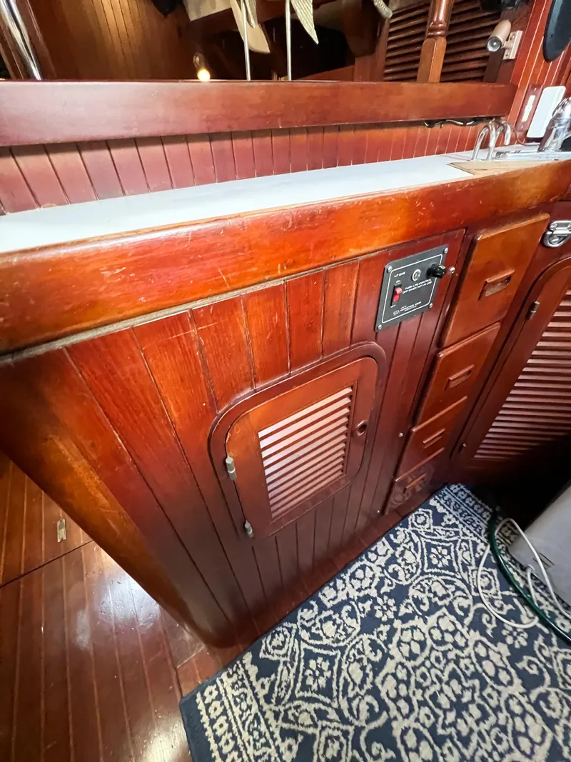 Slide: The Image of Wooden interior of 1986 Tayana Vancouver 42 sailboat with cabinetry and patterned rug. - 46