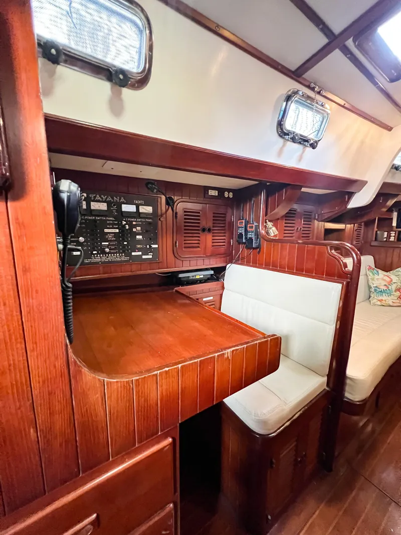 Slide: The Image of Interior of 1986 Tayana Vancouver 42 sailboat with wooden finish and navigation station. - 48