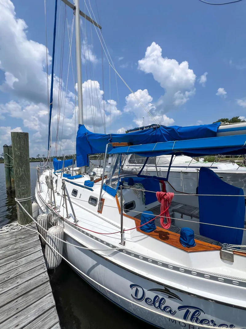 Slide: The Image of 1986 Tayana Vancouver 42 sailboat docked, featuring blue covers and clear sky background. - 5