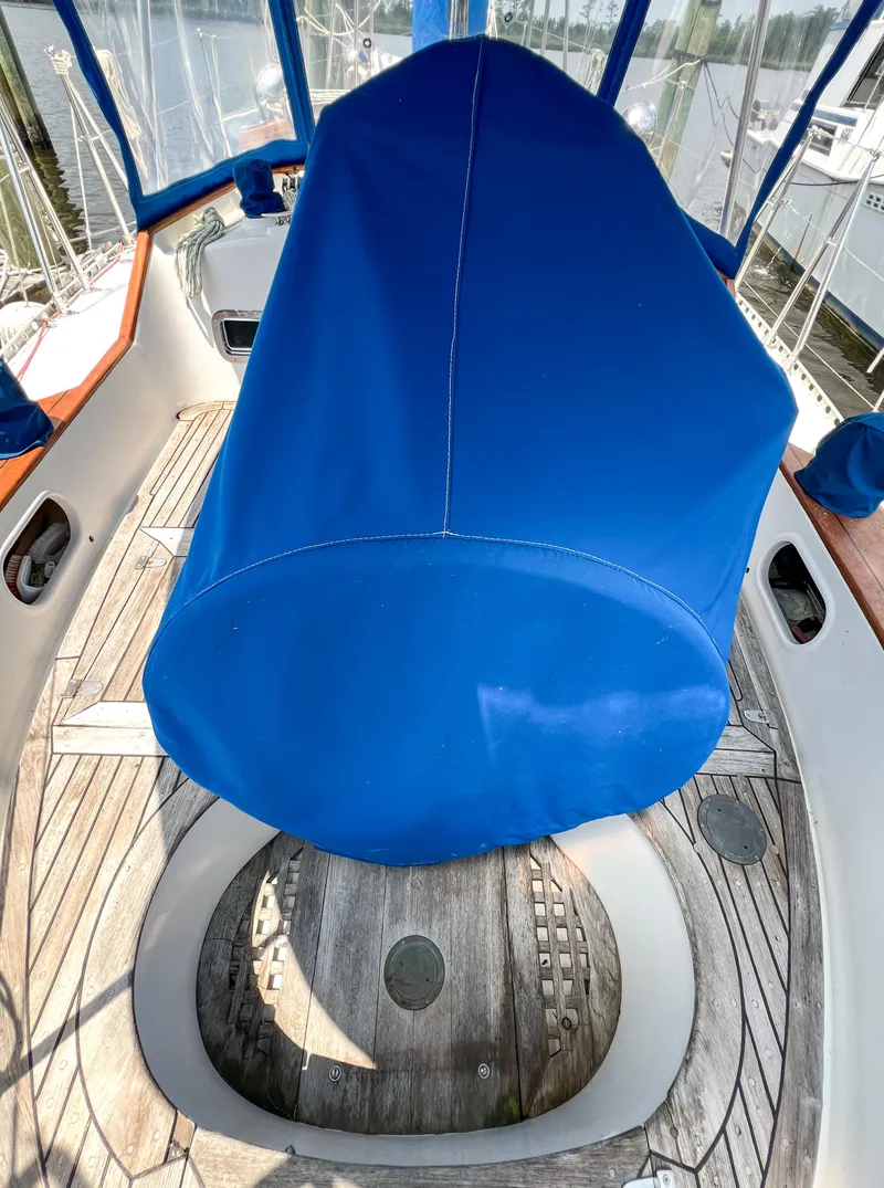 Slide: The Image of 1986 Tayana Vancouver 42 sailboat cockpit with blue cover and wooden deck. - 7