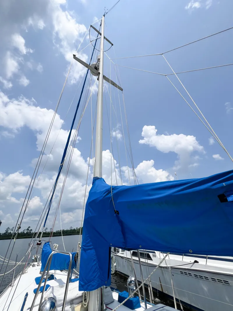 Slide: The Image of Sailboat mast and rigging of 1986 Tayana Vancouver 42 under a cloudy sky. - 9