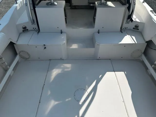 Slide: The Image of 1993 Grady-White Sailfish 252 boat interior, featuring spacious deck and seating area. - 10