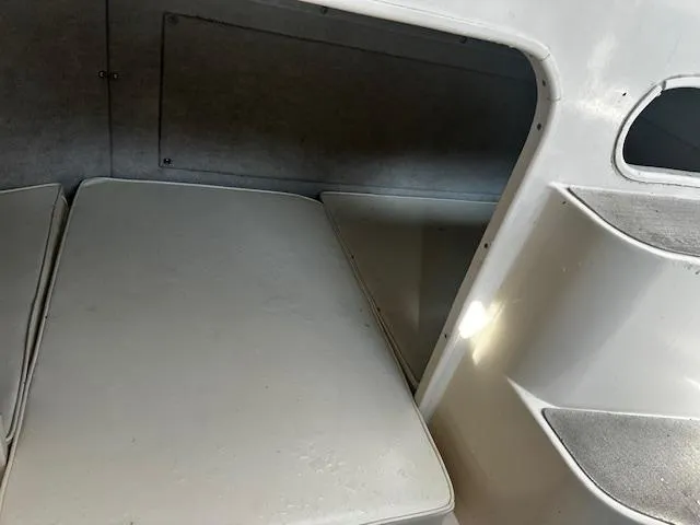 Slide: The Image of Interior cabin of 1993 Grady-White Sailfish 252 boat, featuring cushioned seating. - 15