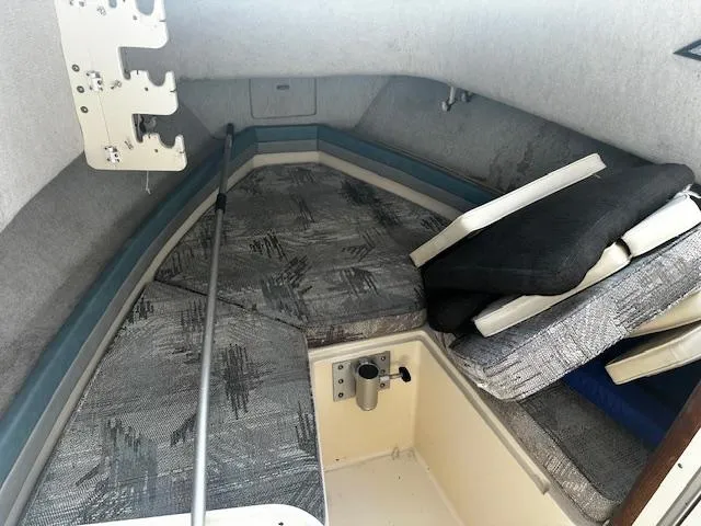 Slide: The Image of 1993 Grady-White Sailfish 252 cabin interior with cushioned seating and storage. - 4