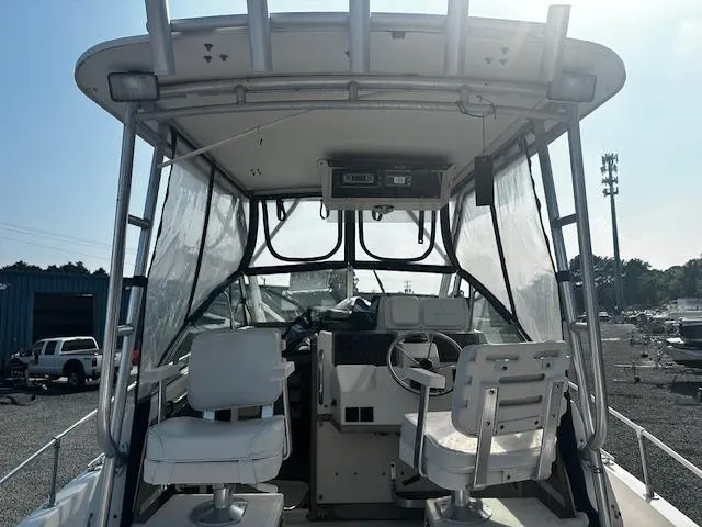 Slide: The Image of 1993 Grady-White Sailfish 252 boat interior with helm, seats, and canopy. - 5