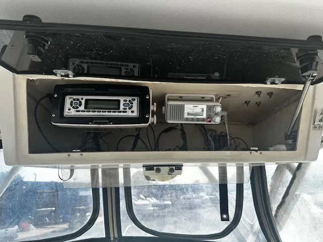 Slide: The Image of 1993 Grady-White Sailfish 252 boat dashboard with radio and electronic equipment. - 8