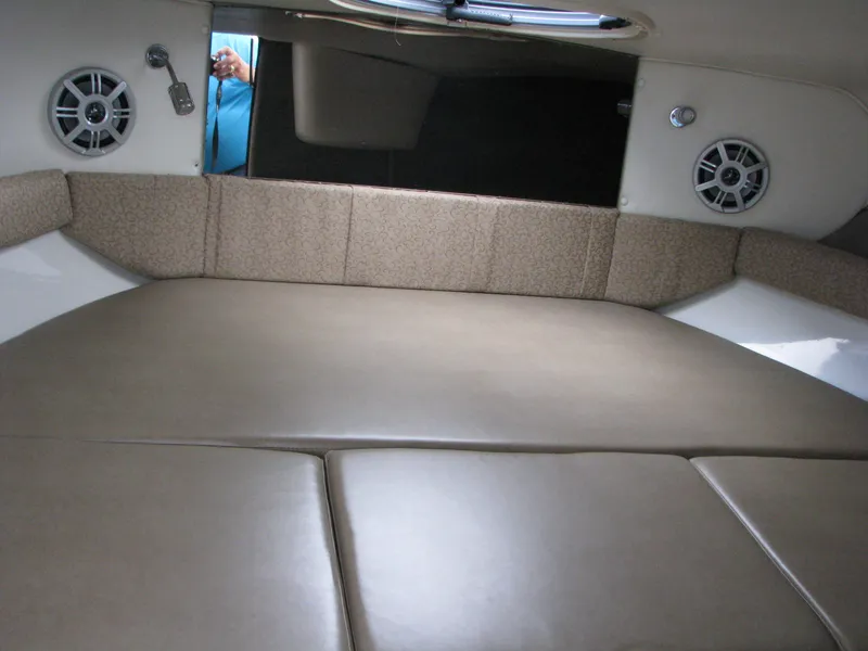 Slide: The Image of Interior cabin of 2017 Stingray 215 CR boat with cushioned seating and speakers. - 10