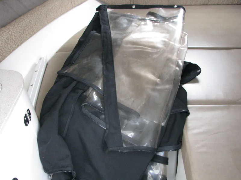 Slide: The Image of 2017 Stingray 215 CR boat interior with clear protective cover on seat. - 13