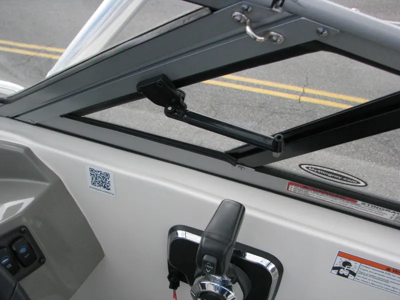 Slide: The Image of 2017 Stingray 215 CR boat dashboard with controls and windshield details. - 15