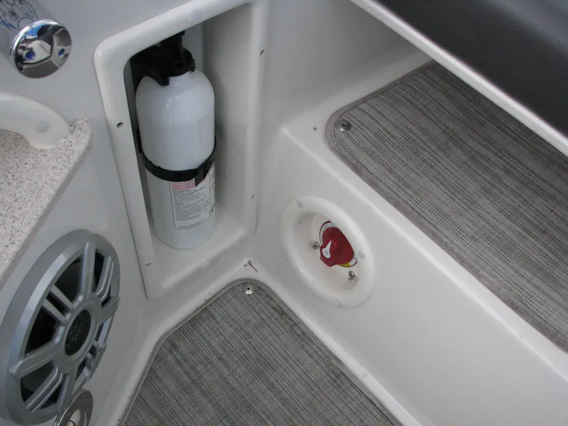 Slide: The Image of Interior of 2017 Stingray 215 CR boat showing fire extinguisher and speaker. - 16