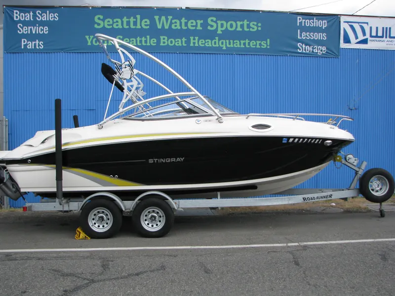 Slide: The Image of 2017 Stingray 215 CR boat on trailer at Seattle Water Sports dealership. - 17