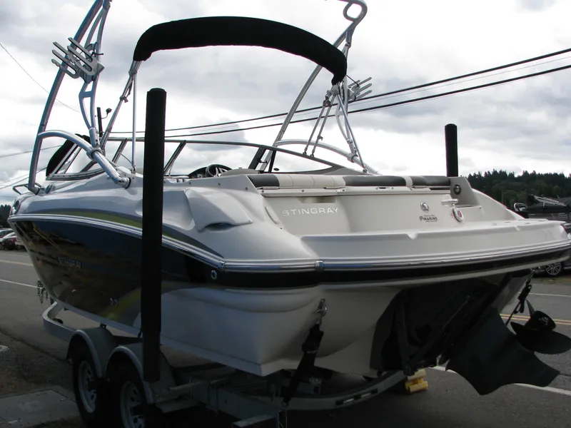 Slide: The Image of 2017 Stingray 215 CR boat on trailer, rear view, overcast sky background. - 19