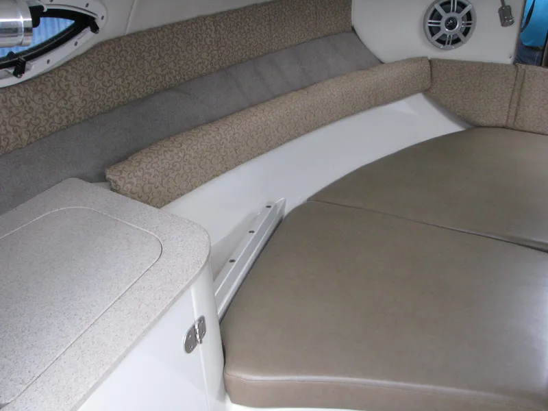 Slide: The Image of 2017 Stingray 215 CR boat interior with cushioned seating and storage. - 8