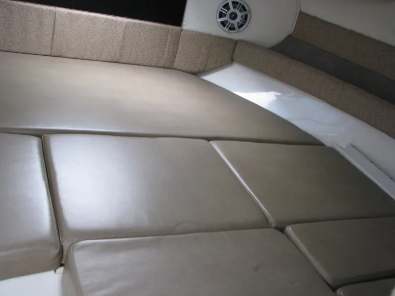 Slide: The Image of 2017 Stingray 215 CR boat interior with cushioned seating and speaker. - 9