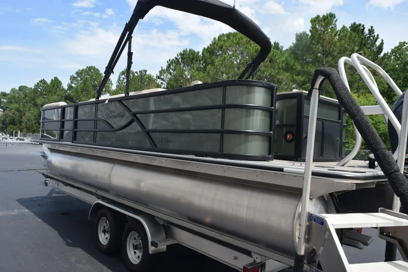 Slide: The Image of 2026 Bentley Pontoons Fish 243 Fish n' Cruise on trailer, parked outdoors. - 5