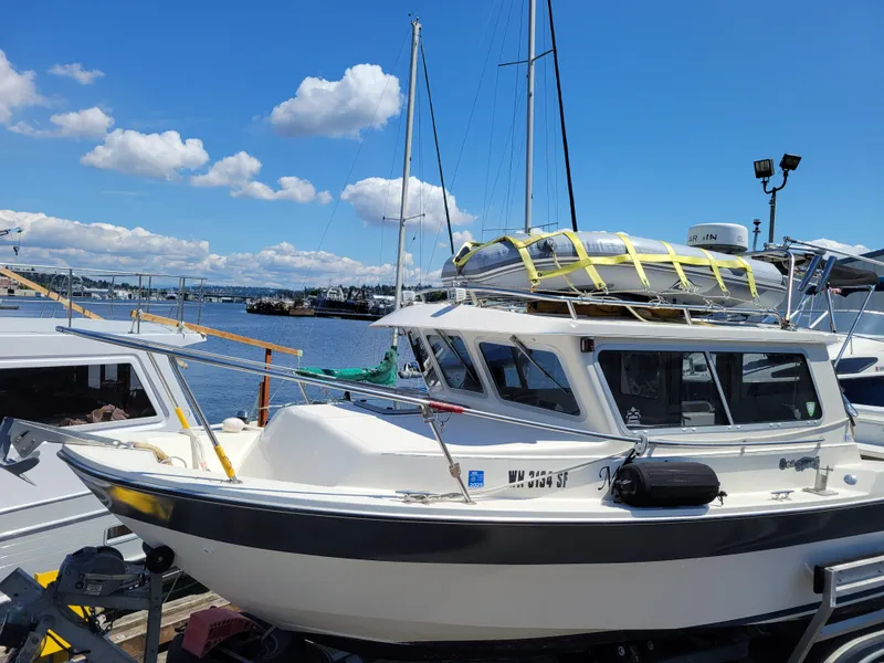 Slide: The Image of 2000 SeaSport 2400 XL Limited boat docked under a clear blue sky. - 1