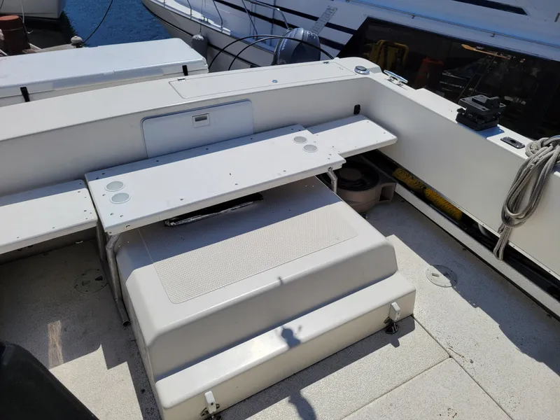Slide: The Image of 2000 SeaSport 2400 XL Limited boat deck with seating and storage compartments. - 13