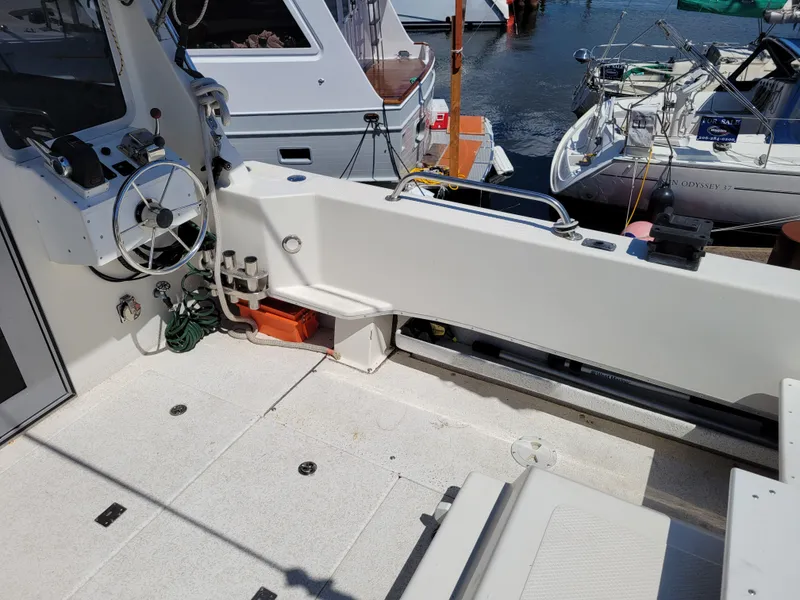 Slide: The Image of Interior view of a 2000 SeaSport 2400 XL Limited boat docked at a marina. - 15