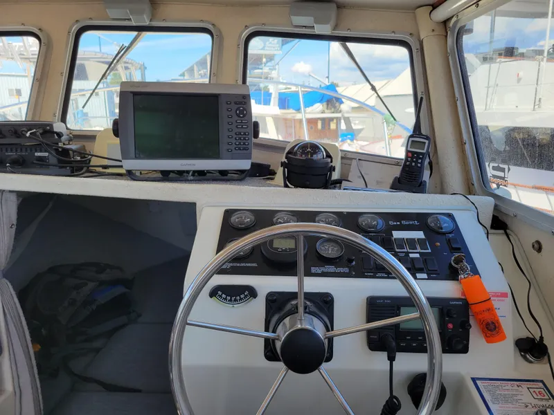 Slide: The Image of Interior view of a 2000 SeaSport 2400 XL Limited boat cockpit with navigation equipment. - 24