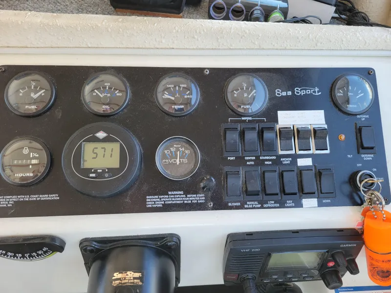 Slide: The Image of Control panel of a 2000 SeaSport 2400 XL Limited boat with gauges and switches. - 25