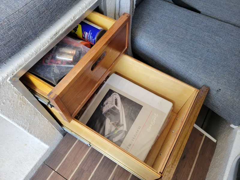 Slide: The Image of Open drawer with SeaSport 2400 XL Limited manual, tools, and supplies on a boat. - 29
