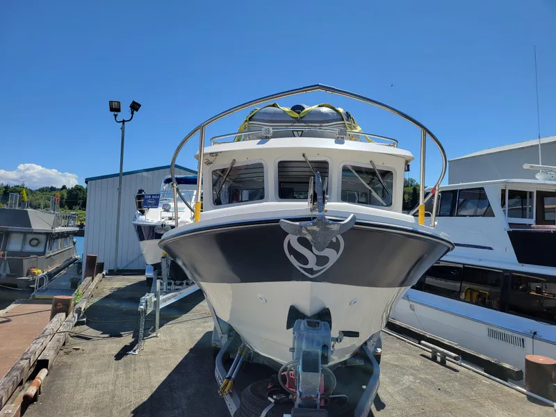 Slide: The Image of SeaSport 2400 XL Limited 2000 boat docked under clear blue sky. - 3