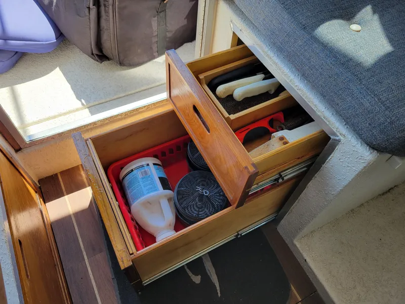 Slide: The Image of Storage drawers in a 2000 SeaSport 2400 XL Limited boat, containing cleaning supplies and tools. - 30