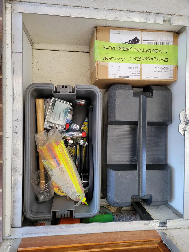 Slide: The Image of Storage compartment with tools and supplies in a 2000 SeaSport 2400 XL Limited boat. - 33