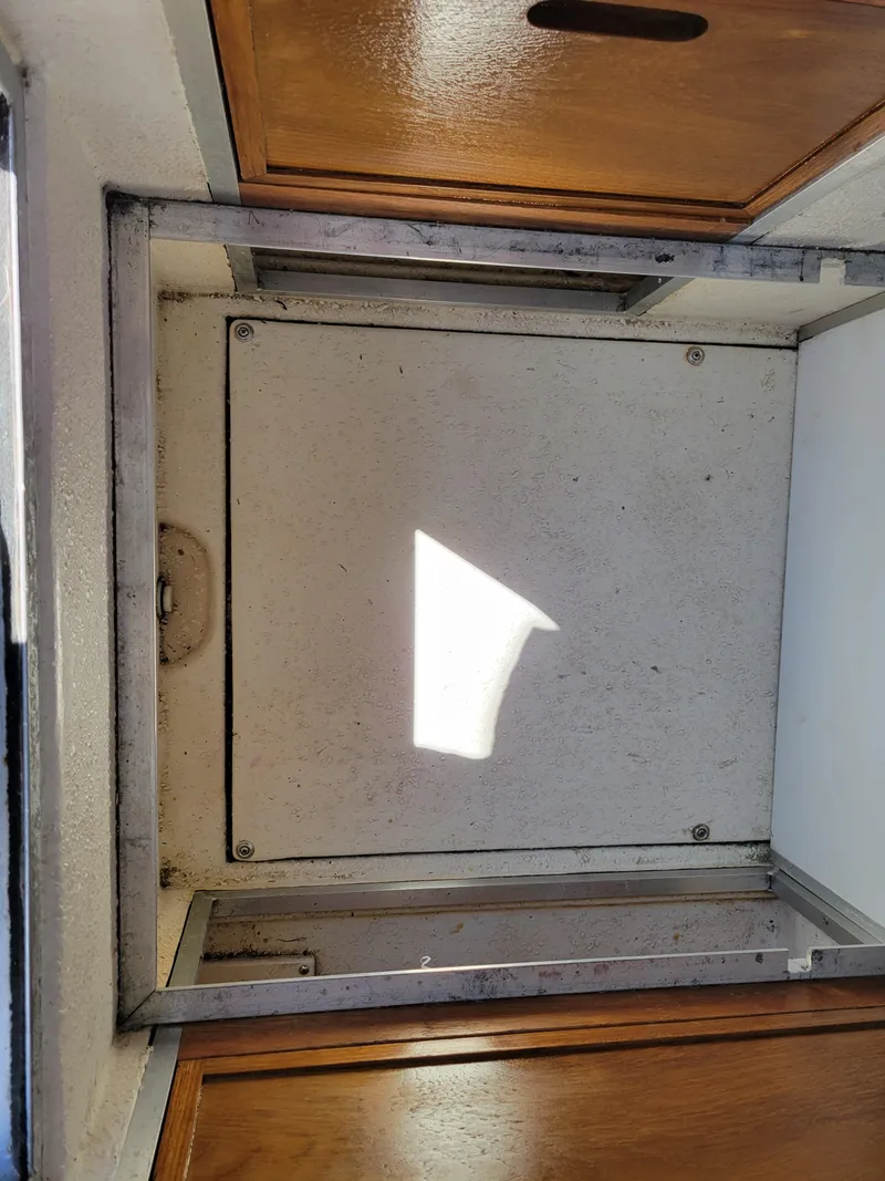 Slide: The Image of Interior view of a 2000 SeaSport 2400 XL Limited boat hatch and wooden cabinet. - 34