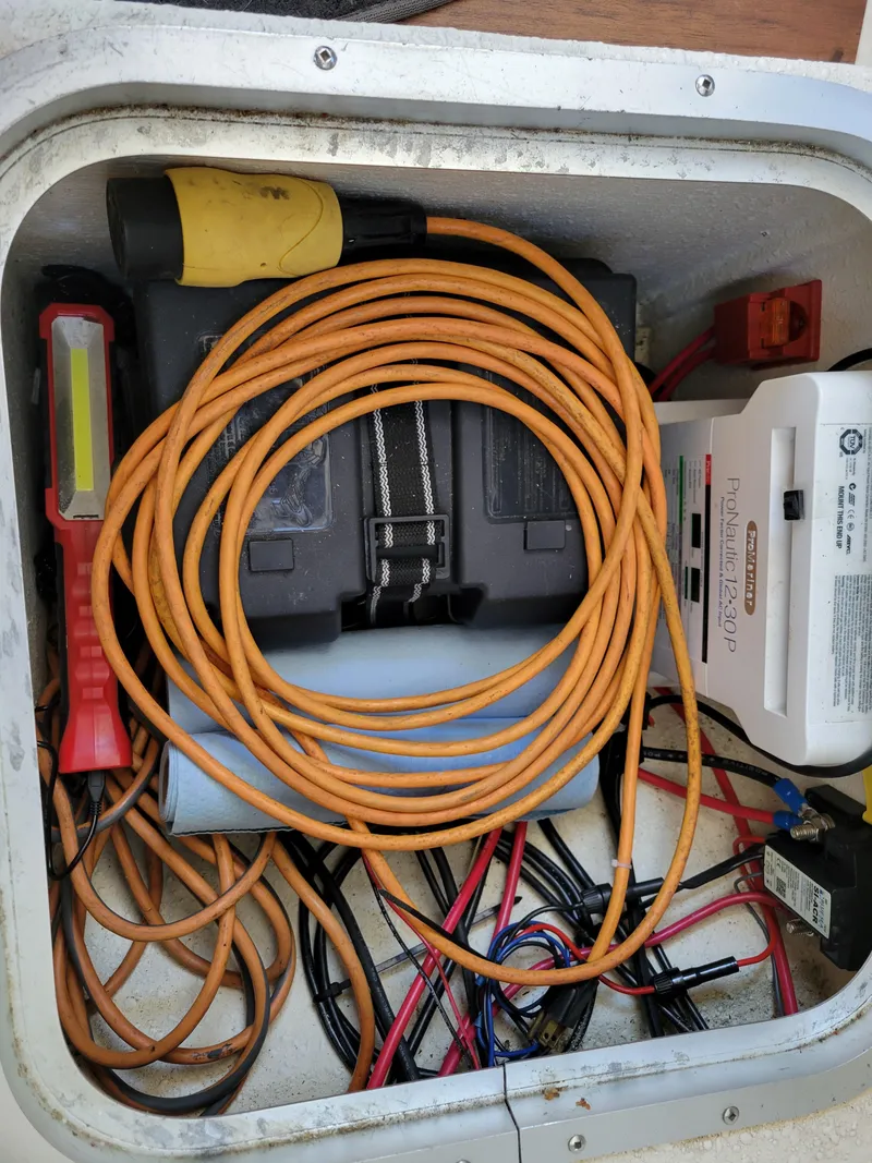 Slide: The Image of Storage compartment with cables and equipment in a 2000 SeaSport 2400 XL Limited boat. - 35