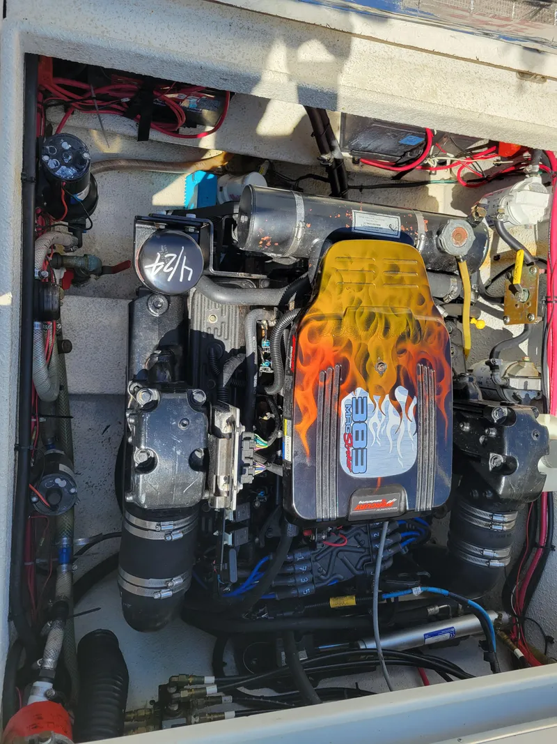 Slide: The Image of Engine compartment of a 2000 SeaSport 2400 XL Limited boat, featuring a powerful inboard motor. - 39