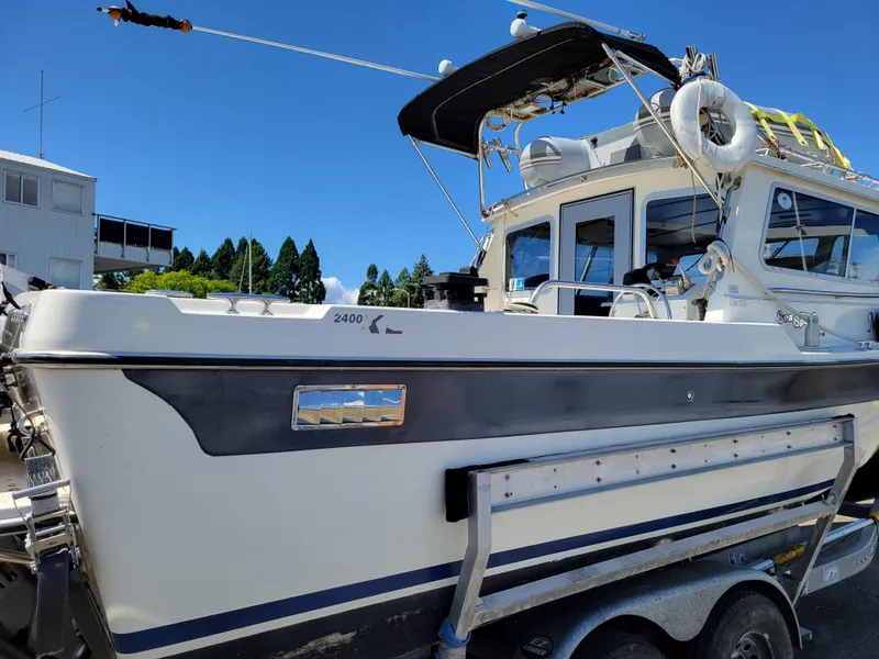 Slide: The Image of SeaSport 2400 XL Limited boat, 2000 model, on trailer under clear blue sky. - 6