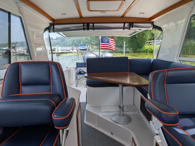 Slide: The Image of Interior of 2018 True North 34OE boat with blue seating and wooden table. - 12