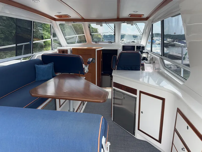 Slide: The Image of Interior of 2018 True North 34OE yacht with blue seating and wooden table. - 14