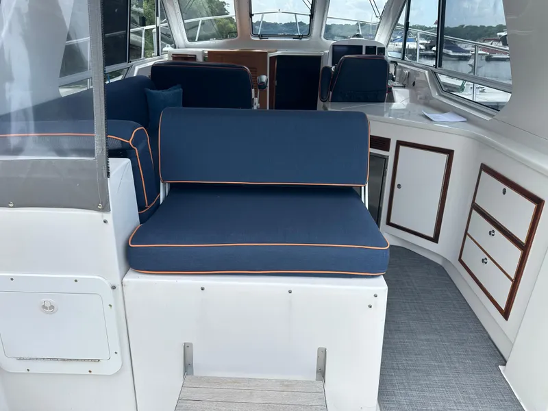 Slide: The Image of Interior of 2018 True North 34OE boat with blue seating and white cabinetry. - 15