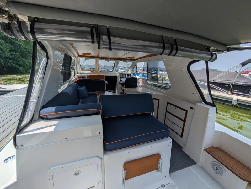 Slide: The Image of Interior of 2018 True North 34OE boat with blue seating and wooden accents. - 27
