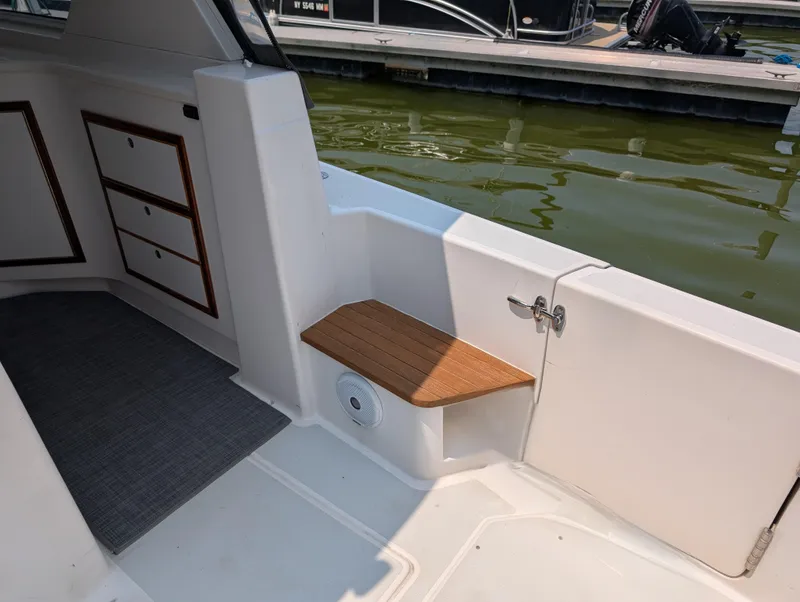 Slide: The Image of Interior view of 2018 True North 34OE boat with wooden seat and storage drawers. - 28