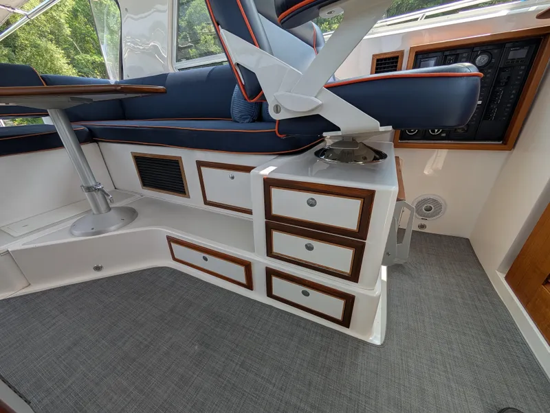 Slide: The Image of Interior of 2018 True North 34OE boat with seating, table, and control panel. - 29
