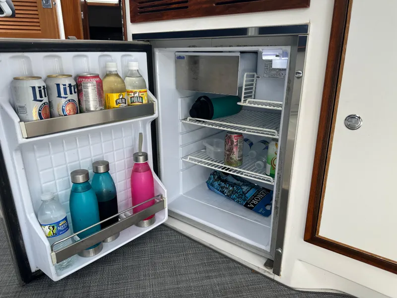 Slide: The Image of Open boat refrigerator with drinks and water bottles, True North 34OE, 2018 model. - 31