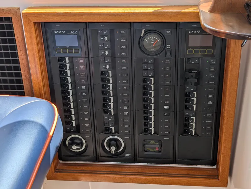 Slide: The Image of Electrical panel on a 2018 True North 34OE boat, featuring switches and gauges. - 32