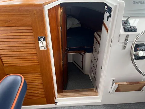 Slide: The Image of Cabin interior of 2018 True North 34OE boat, featuring wooden door and cozy sleeping area. - 34