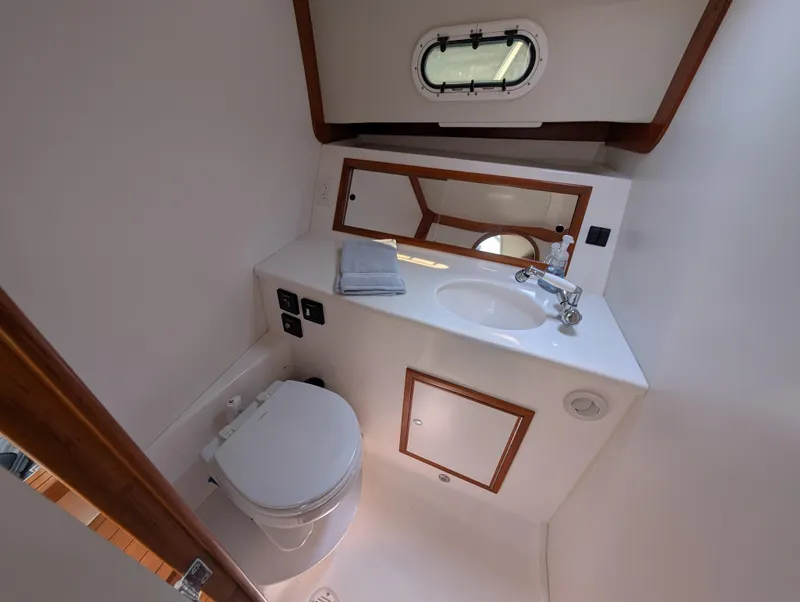 Slide: The Image of Compact bathroom in 2018 True North 34OE yacht with sink, toilet, and mirror. - 36