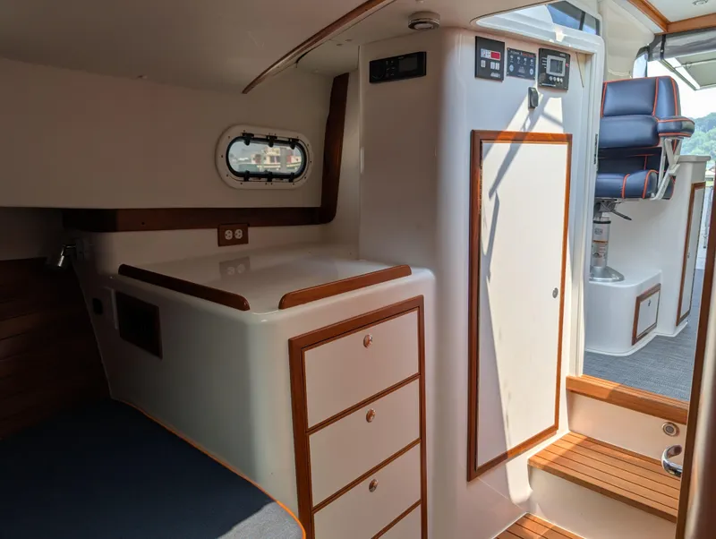 Slide: The Image of Interior of 2018 True North 34OE yacht with wood accents and modern controls. - 38