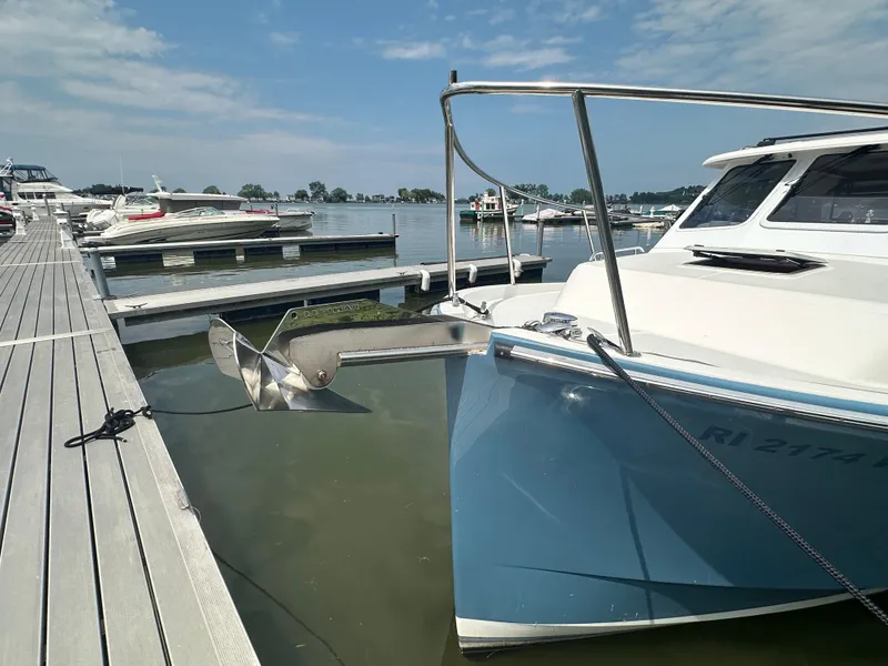 Slide: The Image of 2018 True North 34OE boat docked at marina, calm water, clear sky. - 4